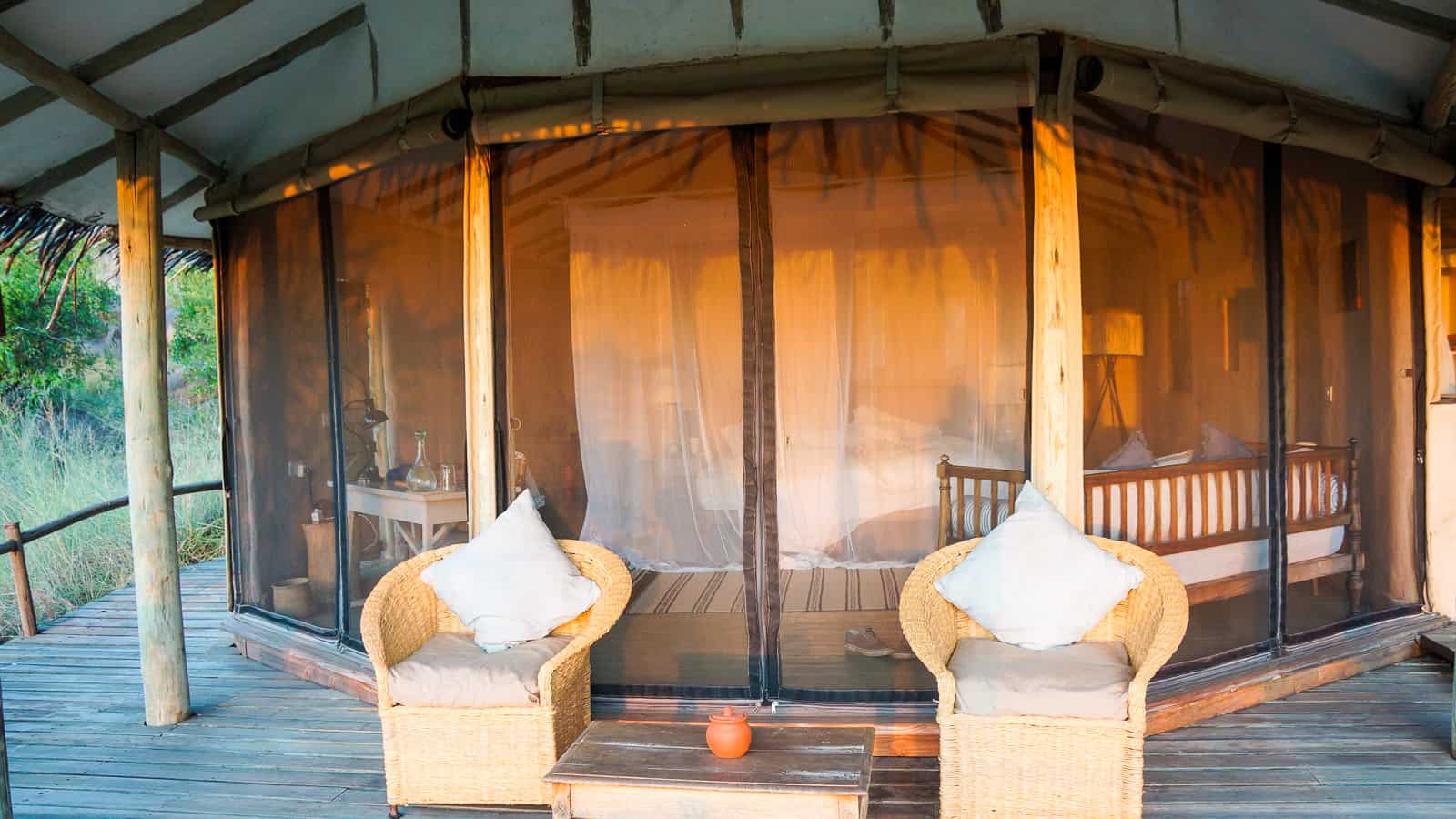 What is the difference between a lodge and tented camp in Tanzania?